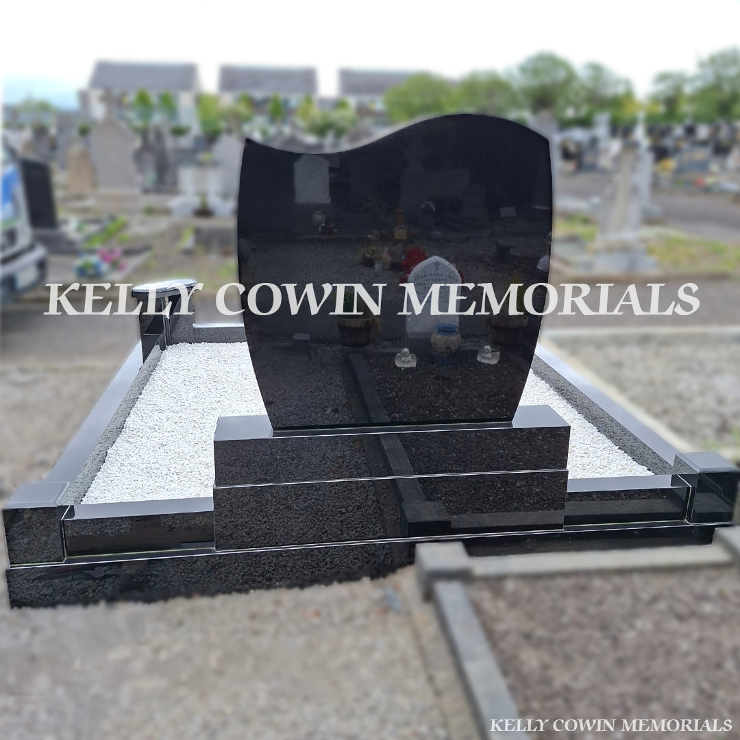 Back view of black granite memorial with kerbing and white chippings