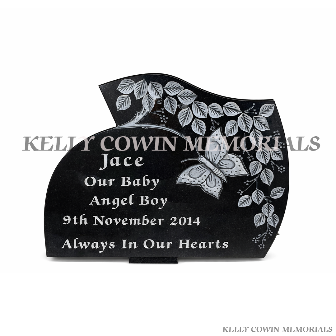 Black carved granite memorial plaque with butterfly design by Kelly Cowin Memorials Ireland – personalised headstone plaque local and nationwide service