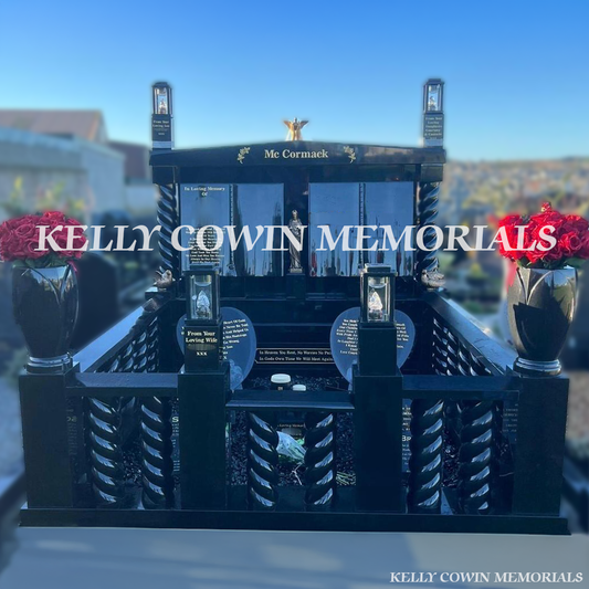 Front view of custom black granite double book headstone with gold inscription, cap and twisted pillars in Wexford cemetery