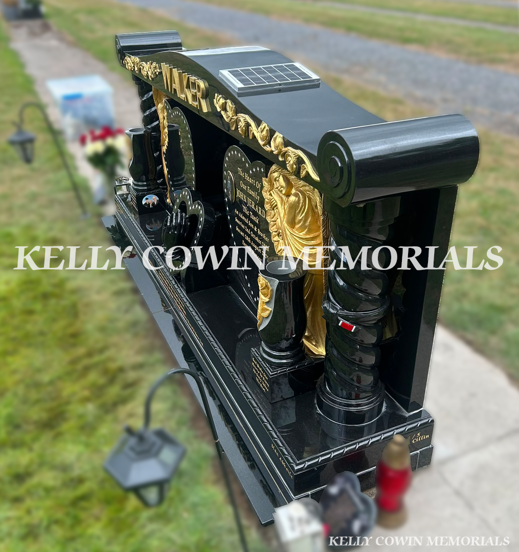 Side view of custom black granite memorial showing twisted pillar, scroll cap and polished granite construction in Newlands Cross Cemetery Dublin.