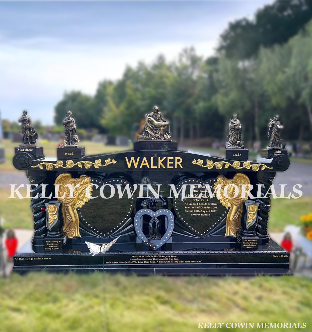 espoke black granite family memorial with carved angels, twisted pillars, gold roses, bronze statues and solar lights in Newlands Cross Cemetery Dublin.