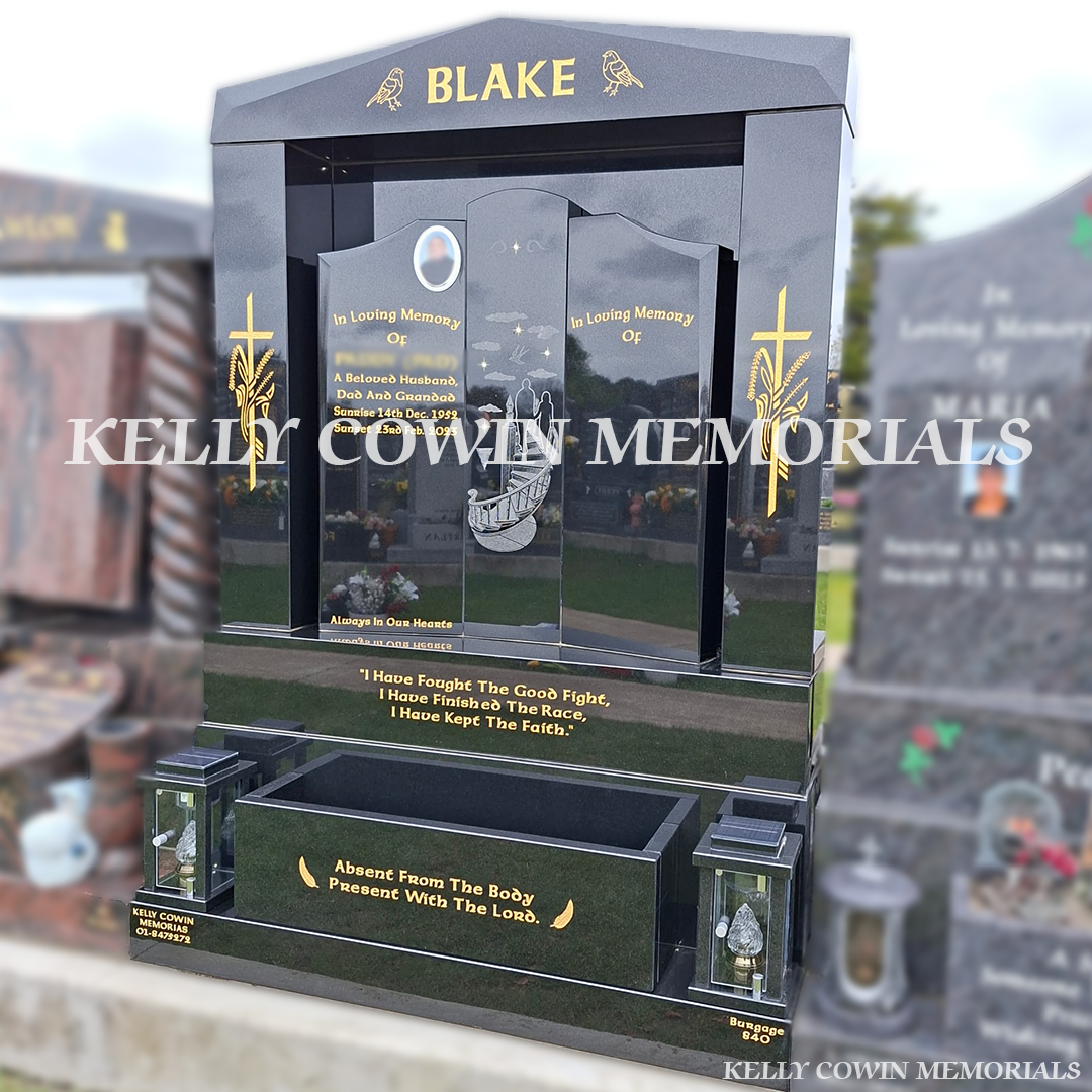 Side view of black granite memorial with pillars, lanterns and flower box