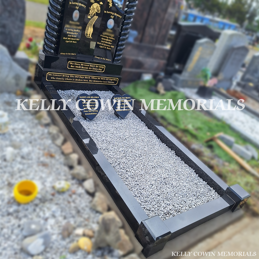 Side view of black granite memorial with kerbing and grey chippings