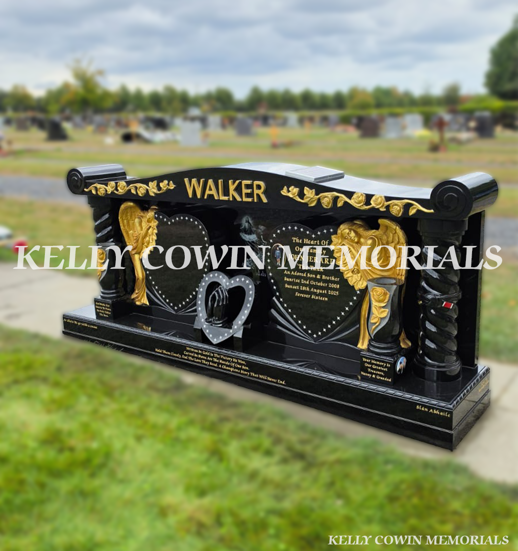 Bespoke black granite family memorial with carved angels, twisted pillars, gold roses, bronze statues and solar lights in Newlands Cross Cemetery Dublin.