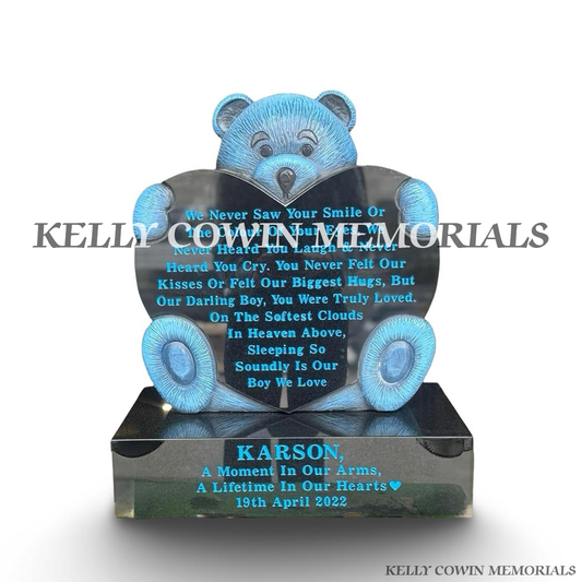 Front view of blue teddy bear holding black granite heart memorial