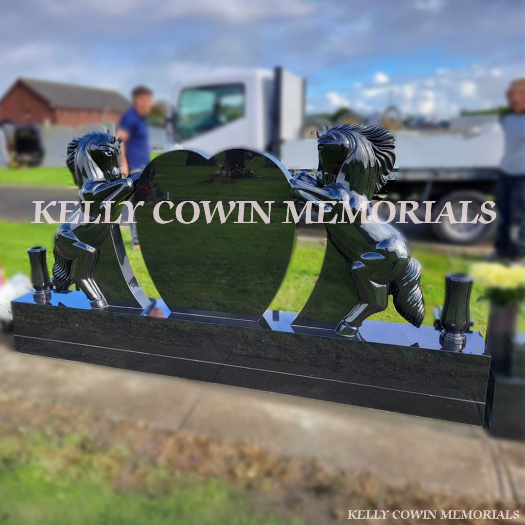 Side View Black granite horse holding heart-shaped memorial headstone with gold engraving and tall vases by Kelly Cowin Memorials Ireland