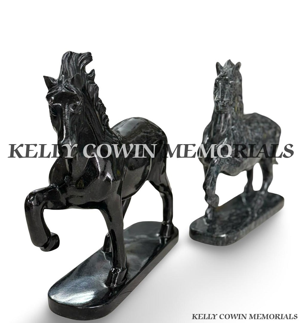 Polished black granite horse memorial ornament with detailed carved mane and raised front leg on matching granite base.