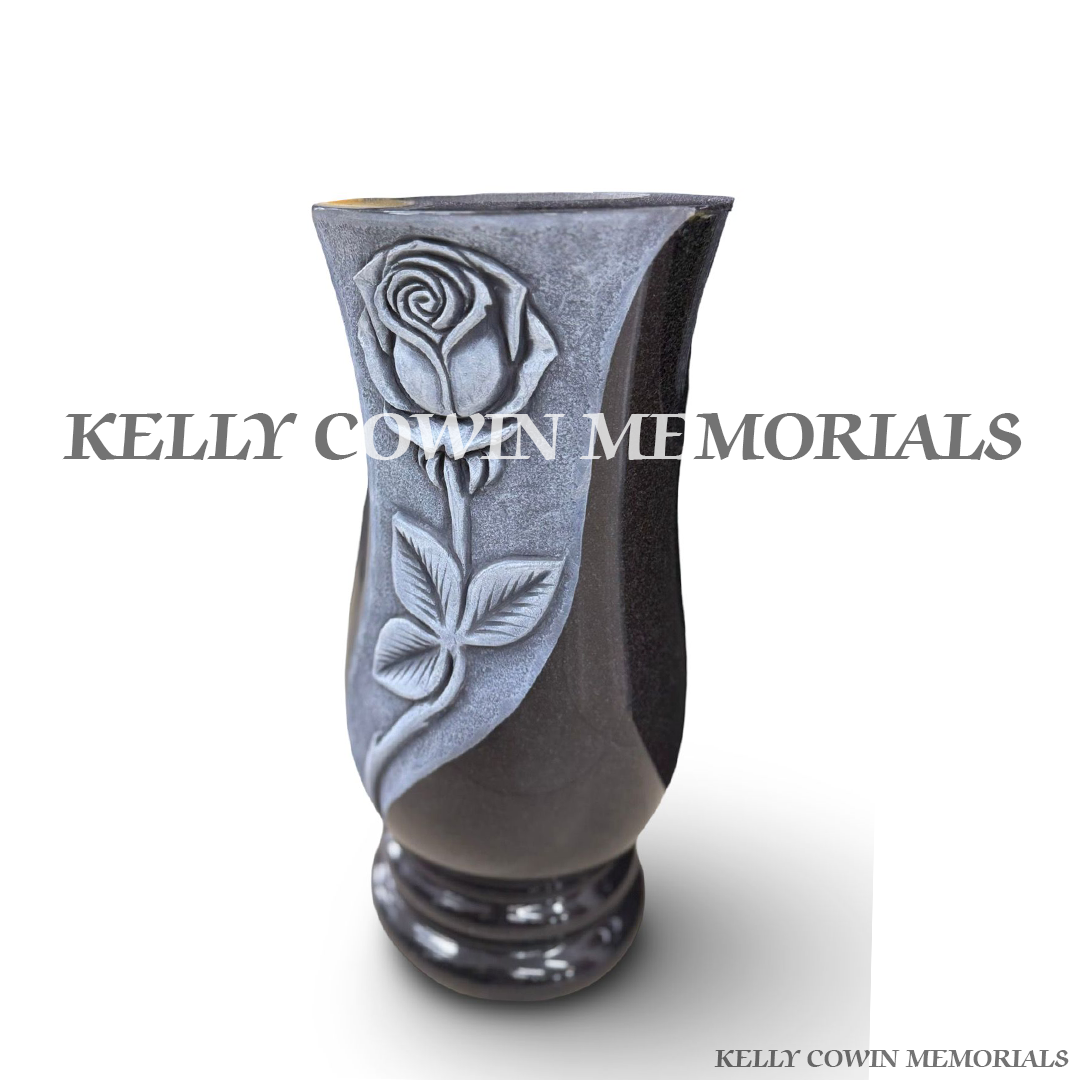 Side view of polished black granite tall vase with carved rose detail