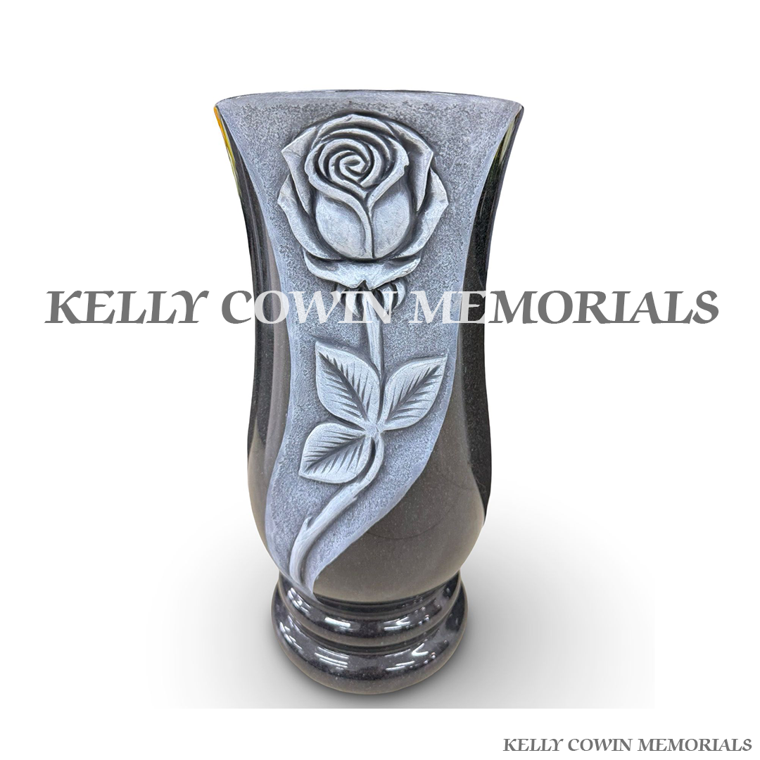 Front view of black granite tall vase with antique carved roses