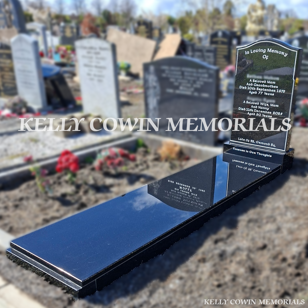 Side view of black granite memorial with kerbing and covering slab