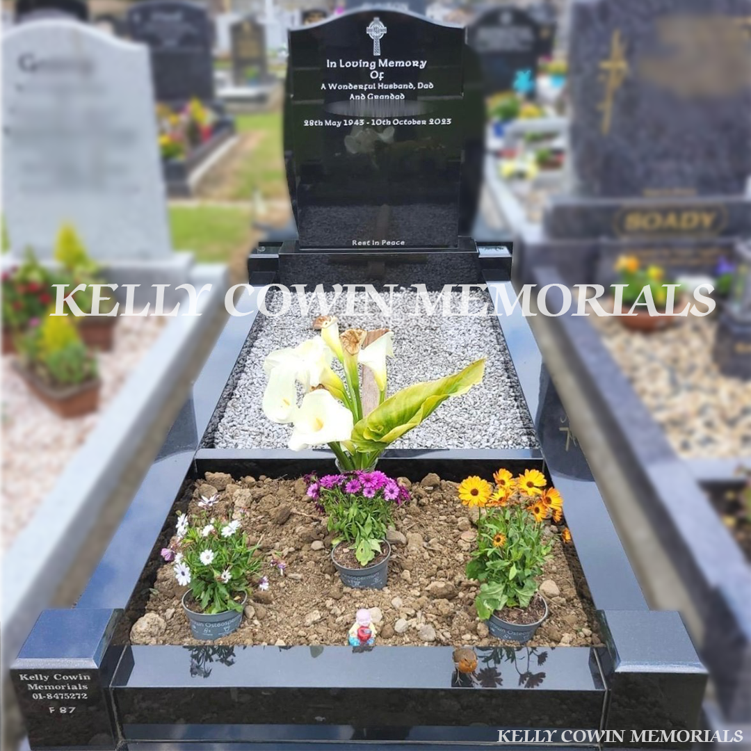 Front view of black granite OG headstone with silver inscription and kerbing