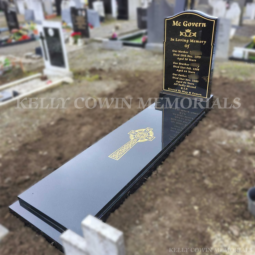 Side profile of an OG-shaped Black Granite headstone with kerbing and full slab, installed by Kelly Cowin Memorials in Glasnevin Cemetery, Dublin.