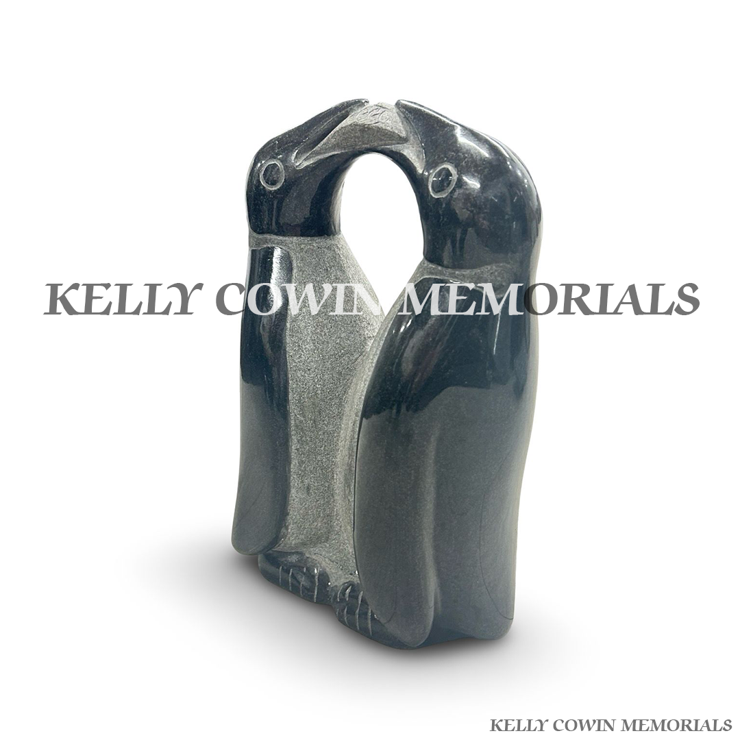 Side view of polished black granite penguin ornament