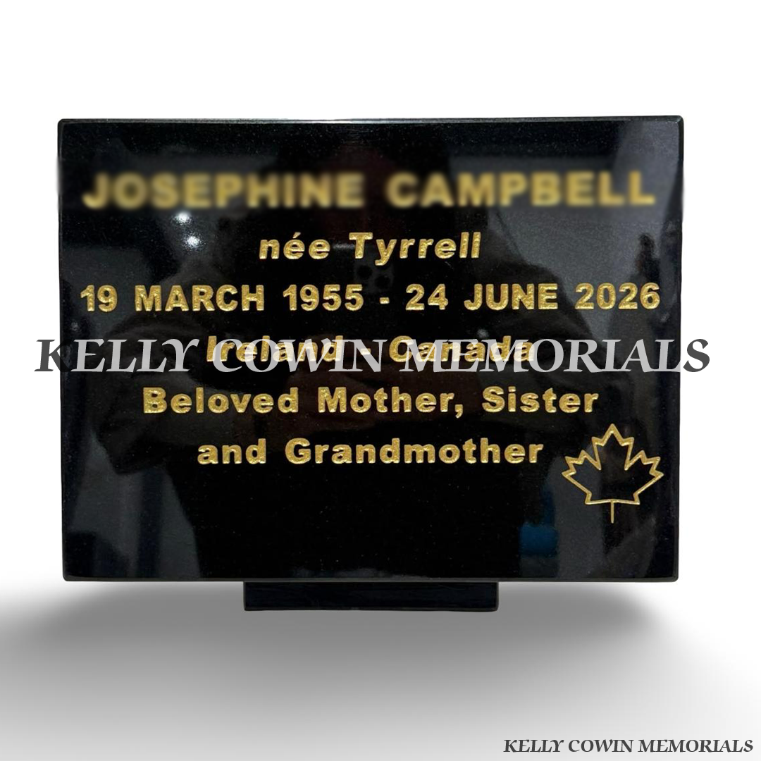 Polished black granite memorial plaque with personalised gold engraved inscription and decorative engraved symbol by Kelly Cowin Memorials Ireland.