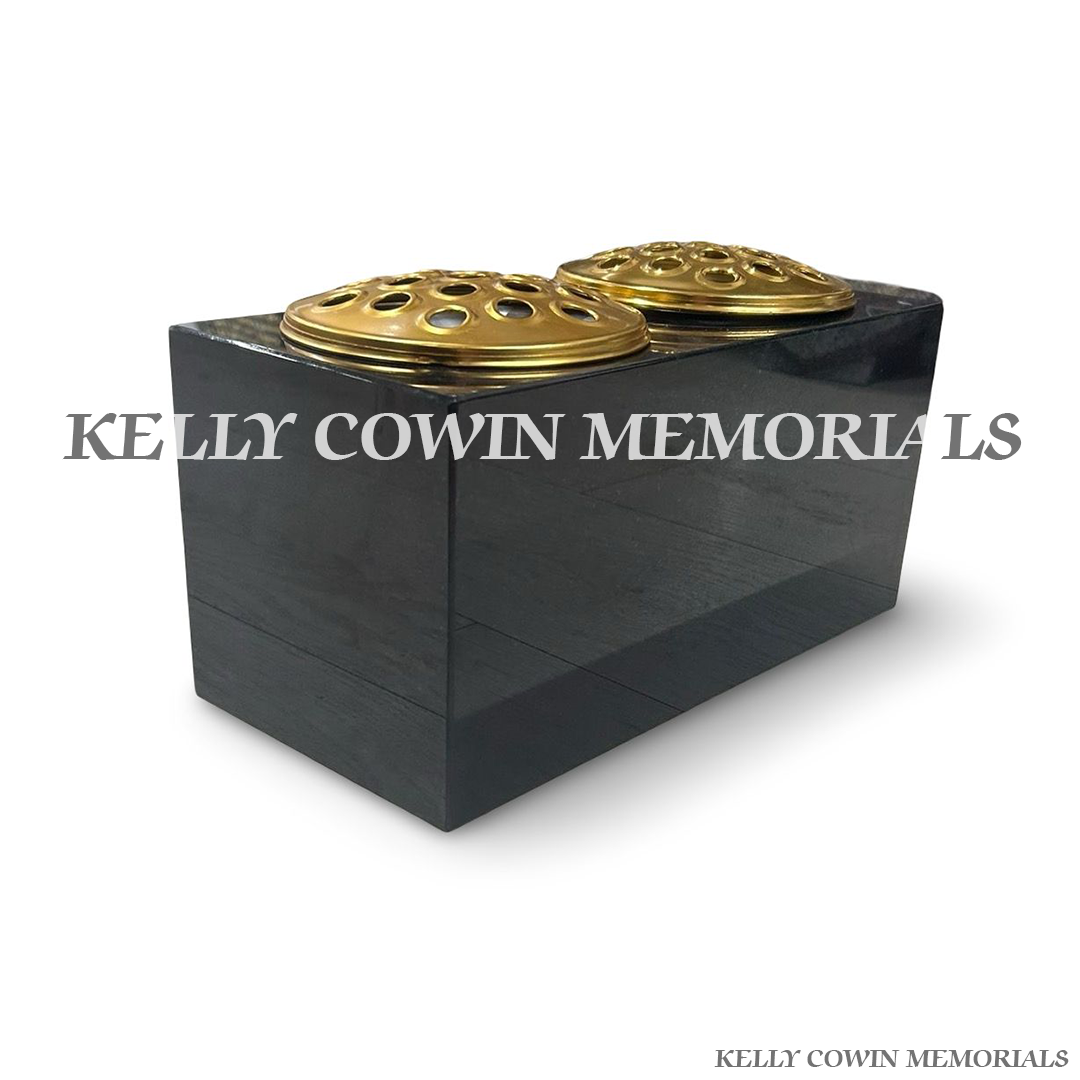 Front view of black granite rectangular vase with two gold lids