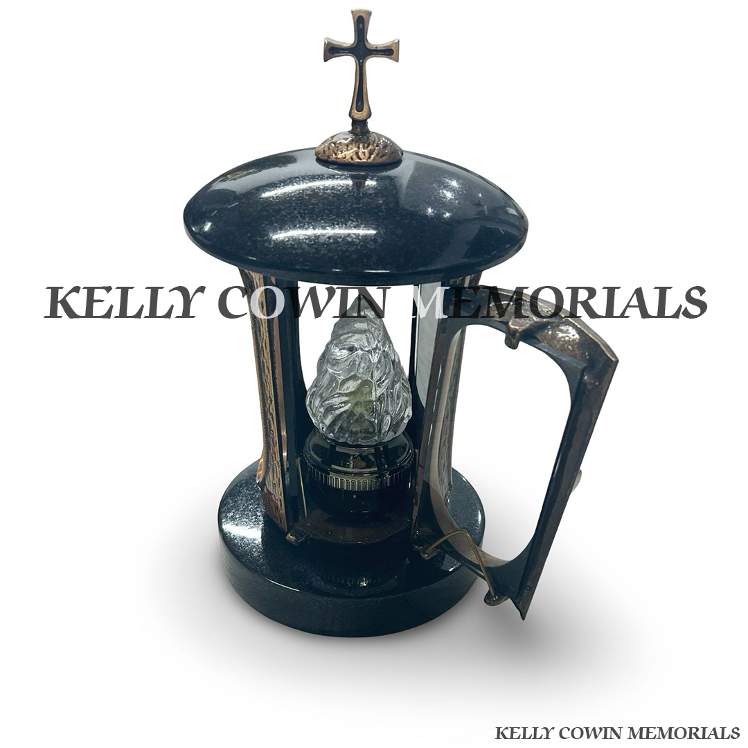 Front view of black granite round lantern with bronze cross and door