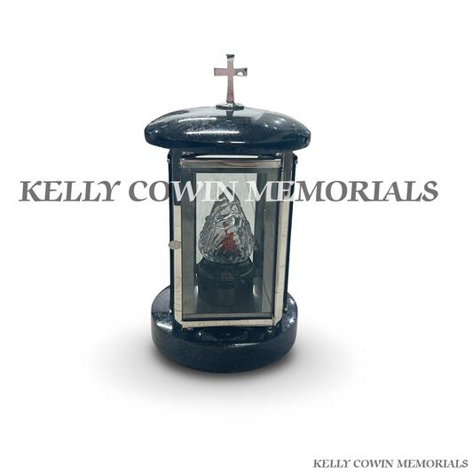 Front view of black granite round lantern with silver cross detail