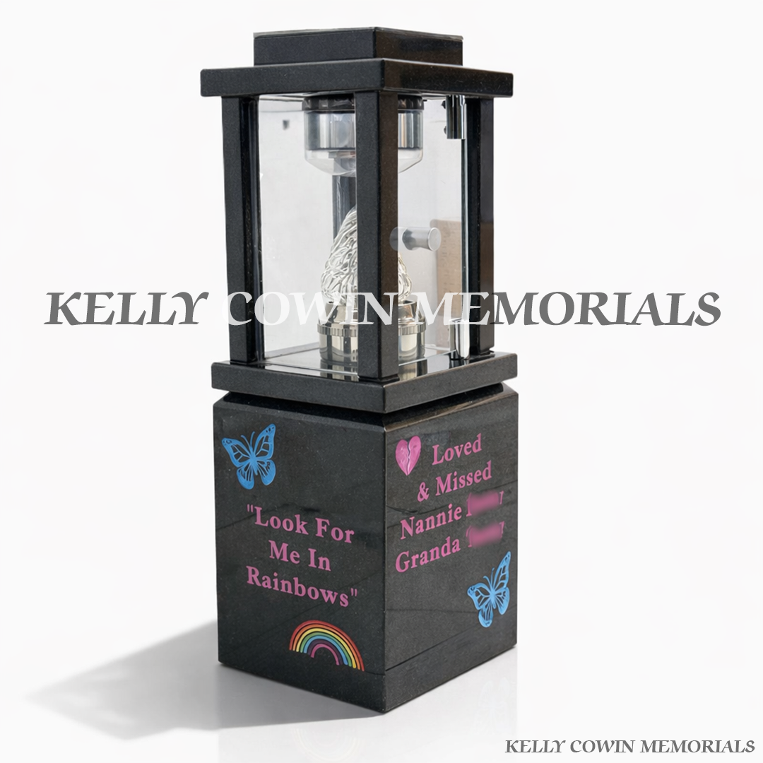 Second side view of black granite lantern on engraved block with candle flame insert