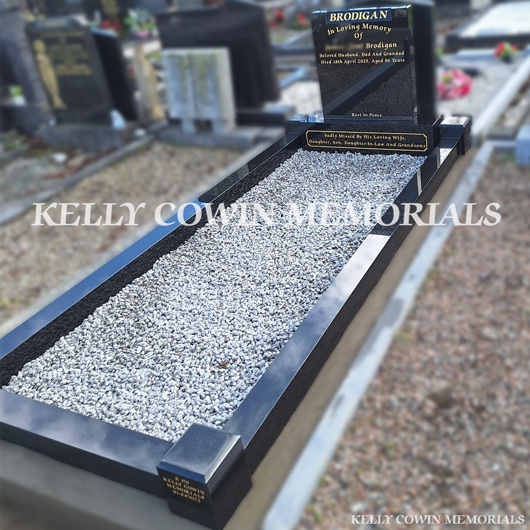 Side view of black granite memorial with kerbing and grey chippings