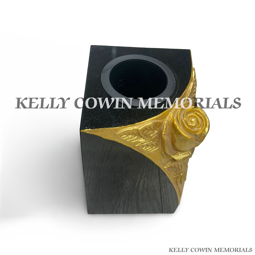 Side view of polished black granite vase with carved rose detail