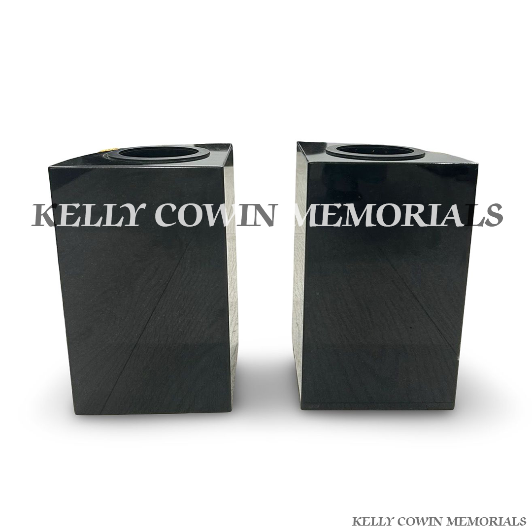 Back view of polished black granite vase with carved rose detail