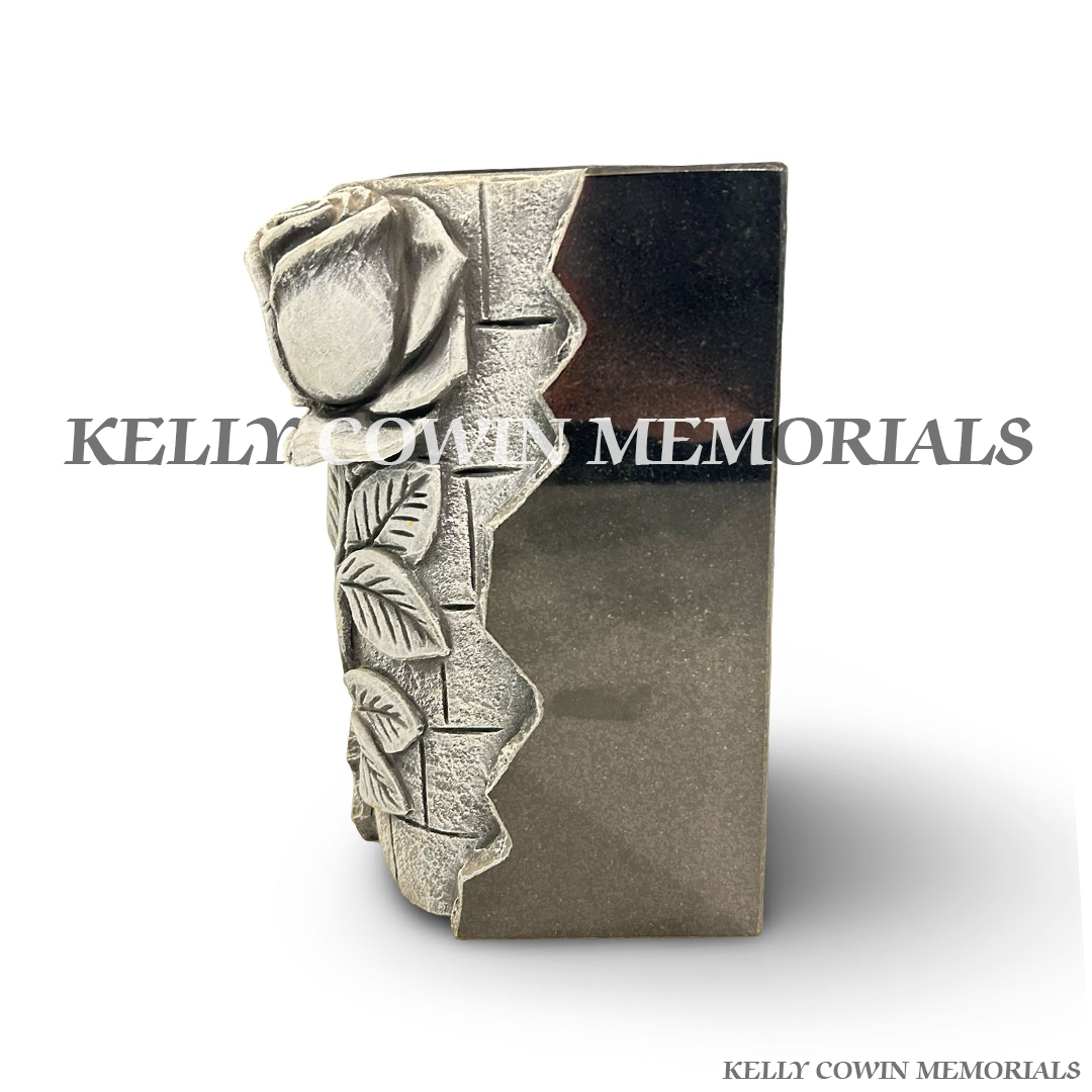 Side view of polished black granite vase with antique rose carving
