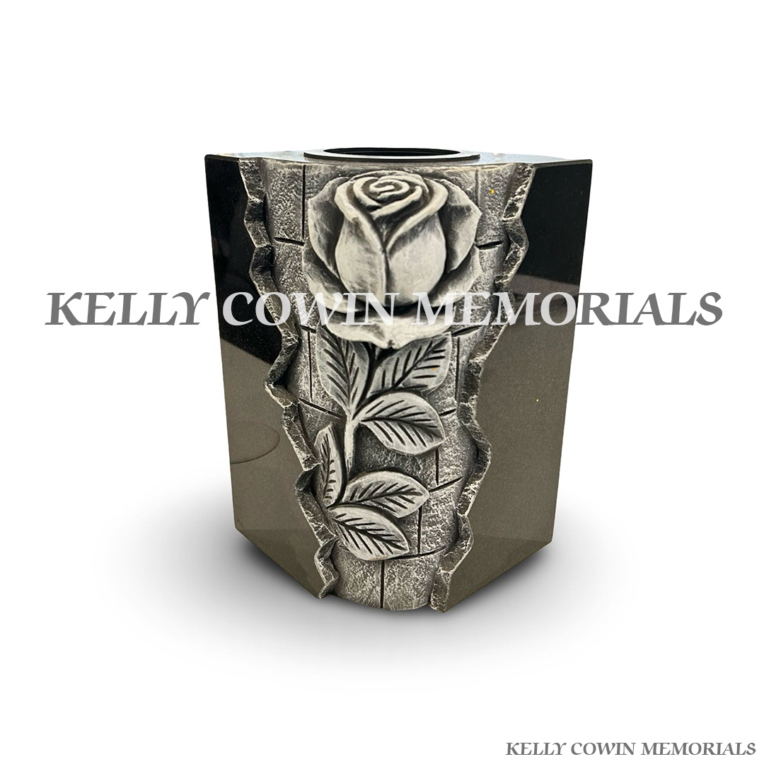 Front view of black granite square vase with carved rose design