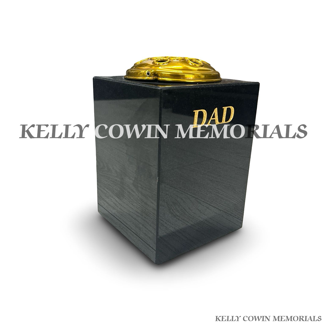 Side view of polished black granite square vase with gold lid