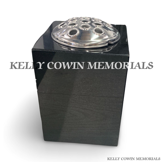 Front view of black granite square vase with silver lid