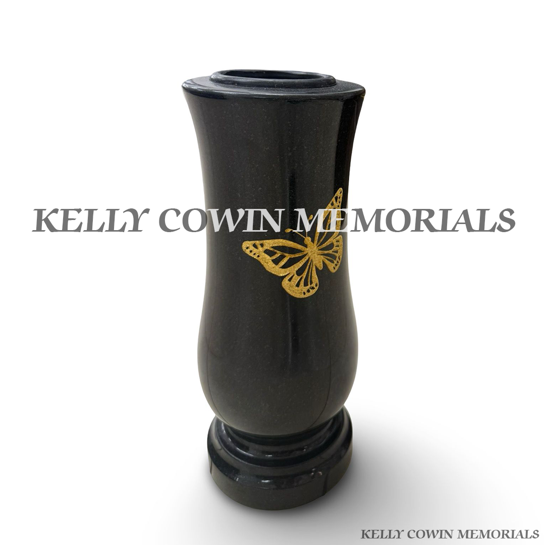 Side view of polished black granite vase with engraved butterfly detail