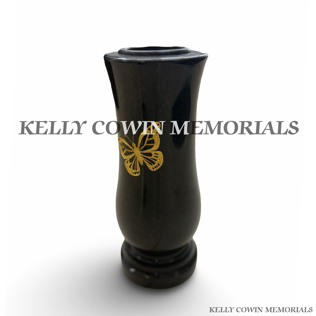 Side view of polished black granite vase with engraved butterfly detail