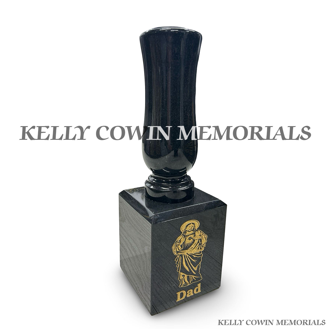 Side view of black granite tall vase mounted on block with gold engraving