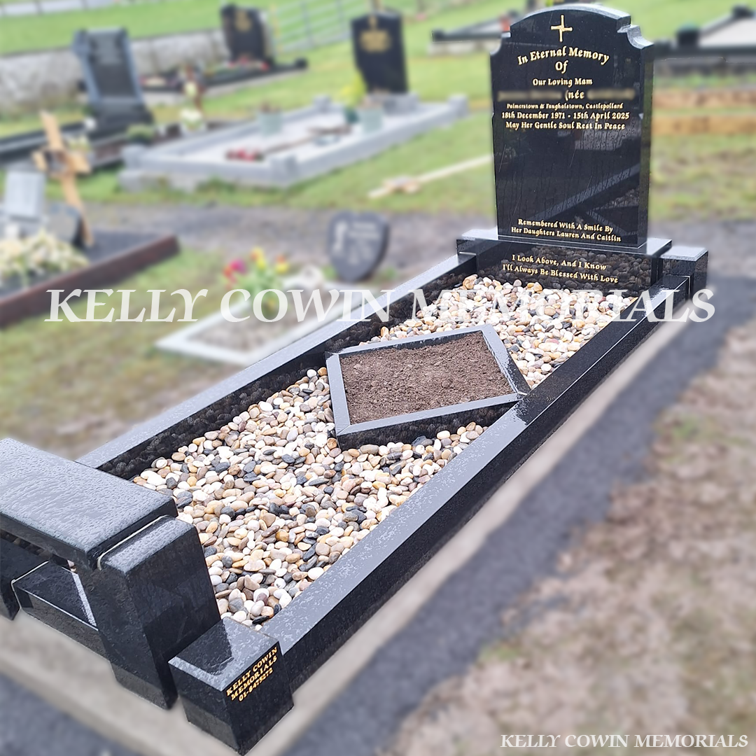 Side view of black granite memorial with kerbing, garden area and bench