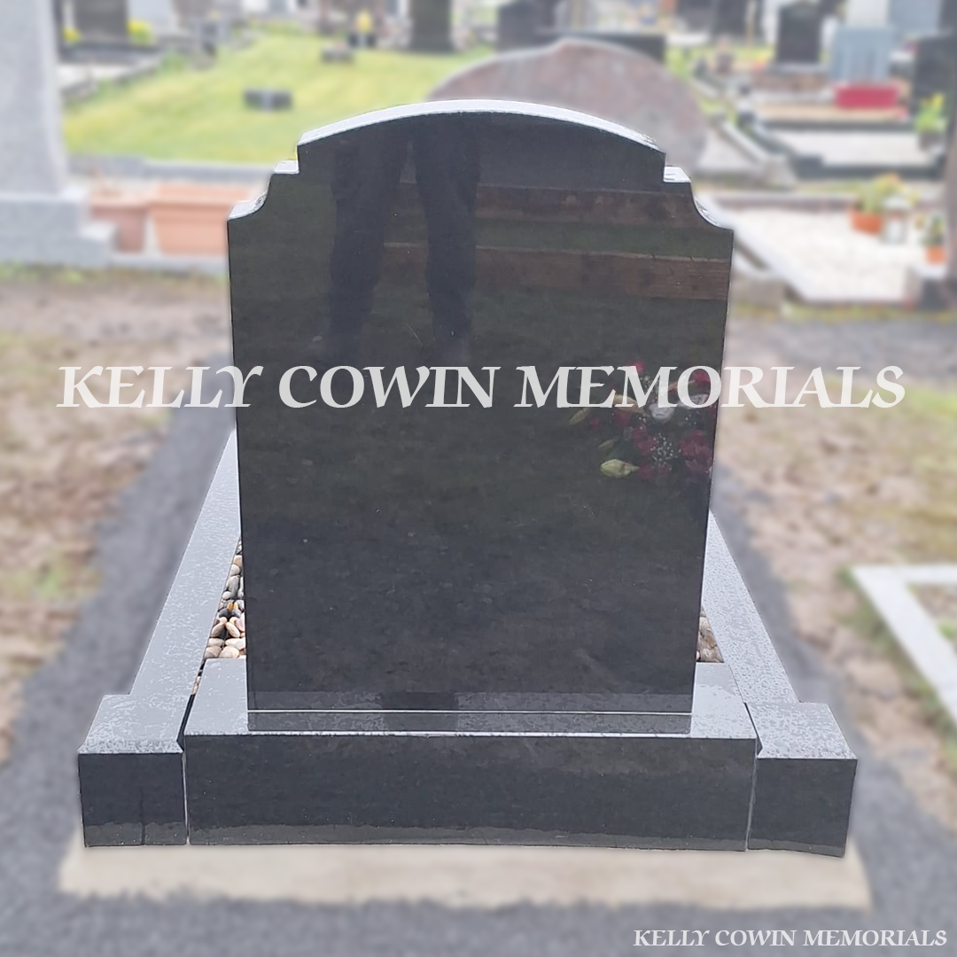 Back view of black granite memorial with kerbing
