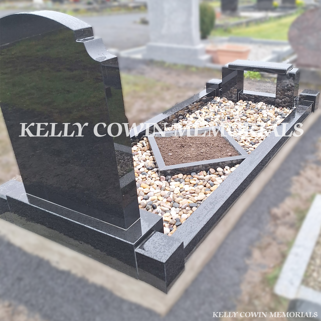 Back view of black granite memorial with kerbing, garden area and bench
