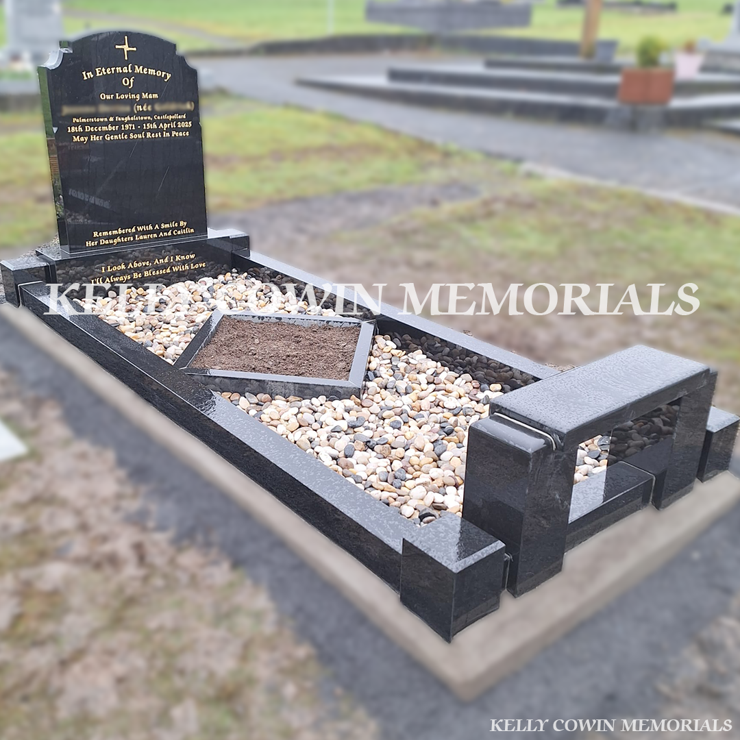 Side view of black granite memorial with kerbing, garden area and bench