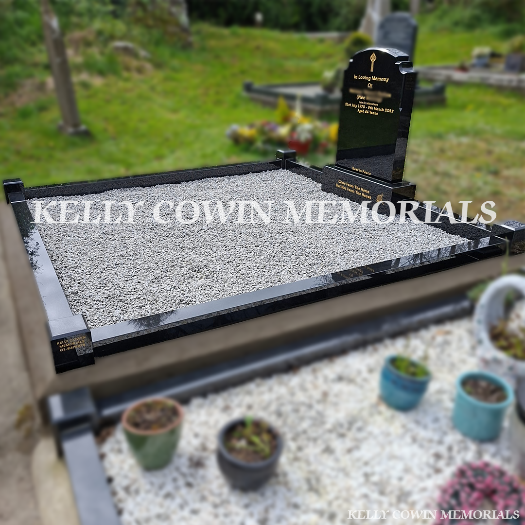 Side view of black granite memorial with kerbing and grey chippings