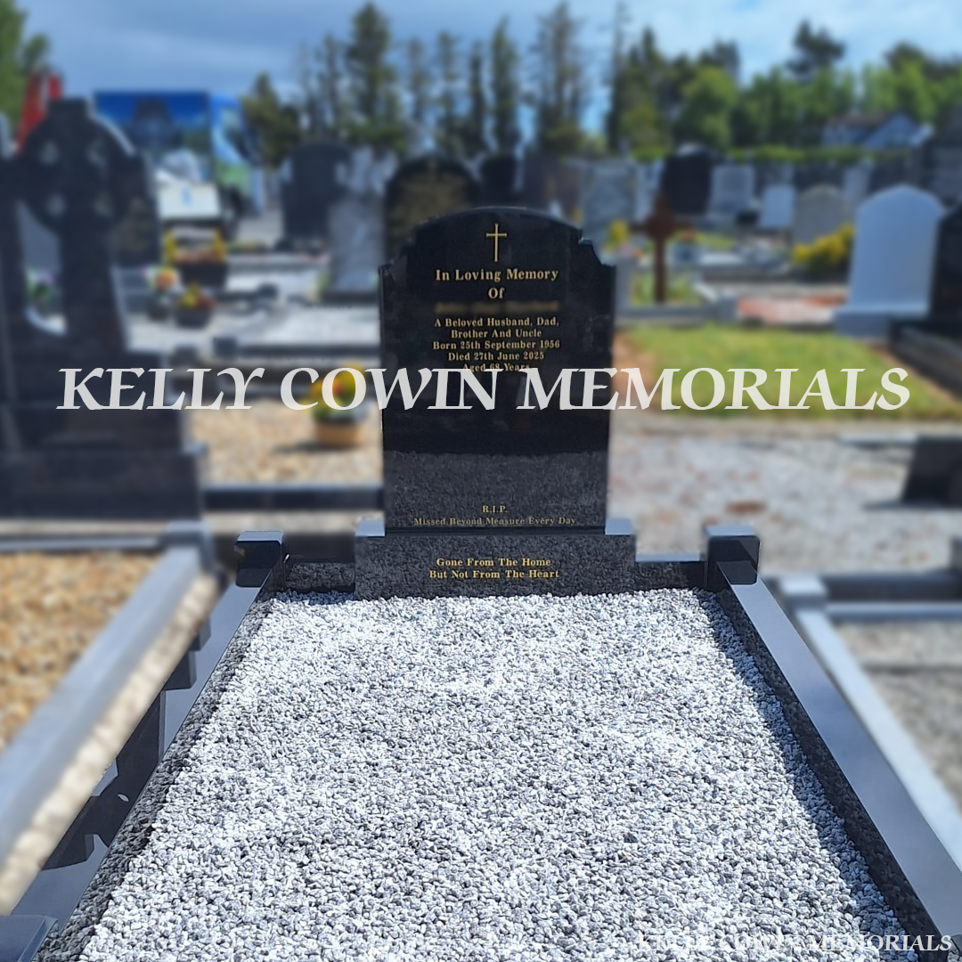 Close-up of gold engraved inscription on black granite headstone