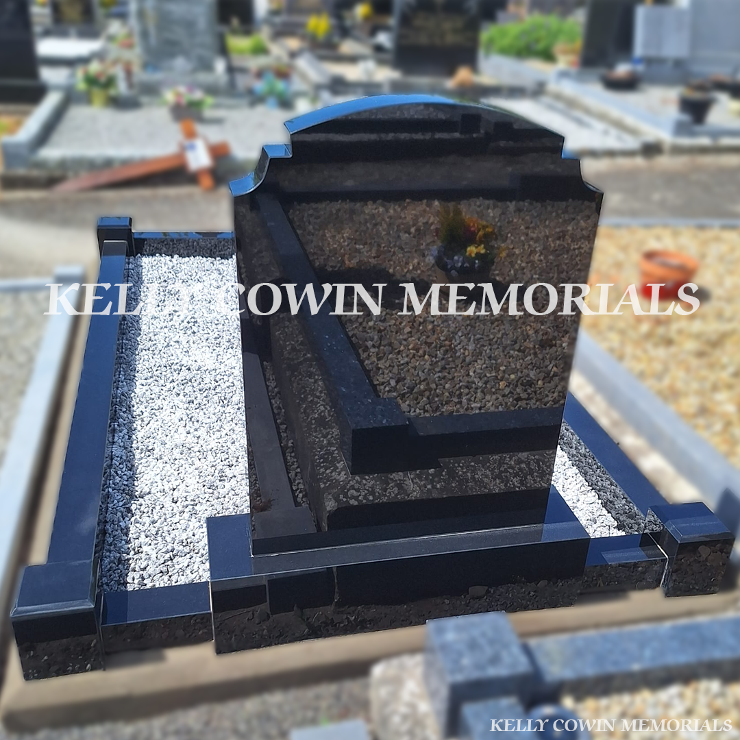 Side view of black granite memorial with kerbing and mixed chippings