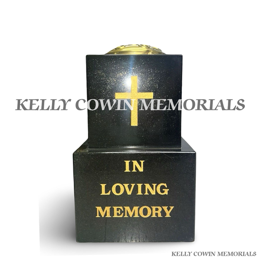 Front view of black granite vase on block with gold lid and cross engraving