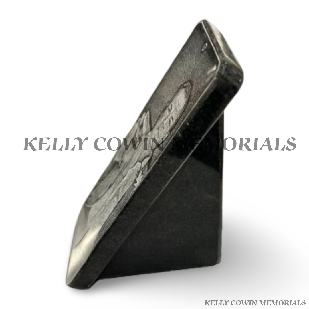 Side view of black granite memorial plaque with angled base