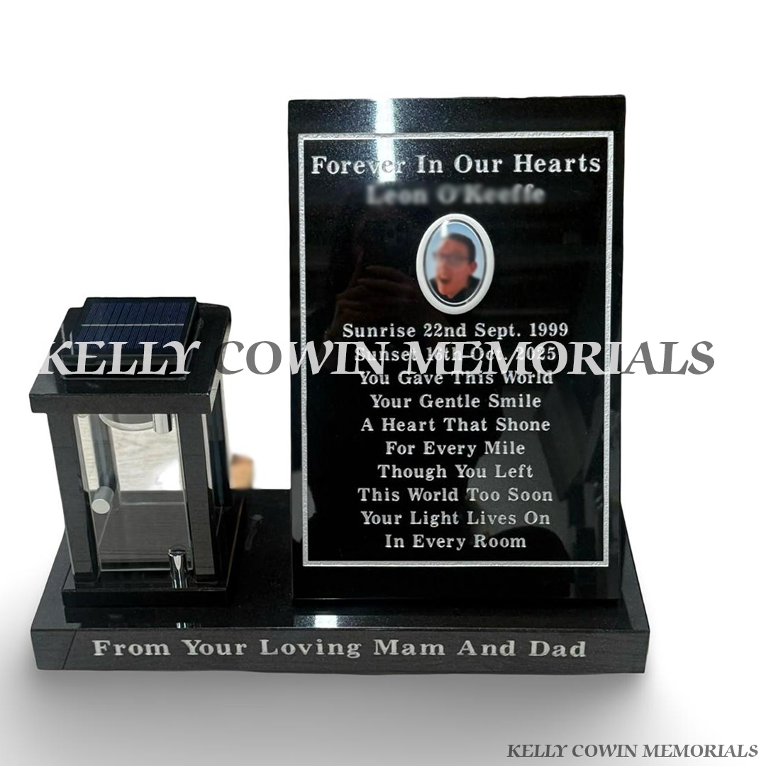 Black granite memorial plaque on plinth with silver engraved inscription, ceramic photo and matching solar memorial lantern by Kelly Cowin Memorials in Ireland.