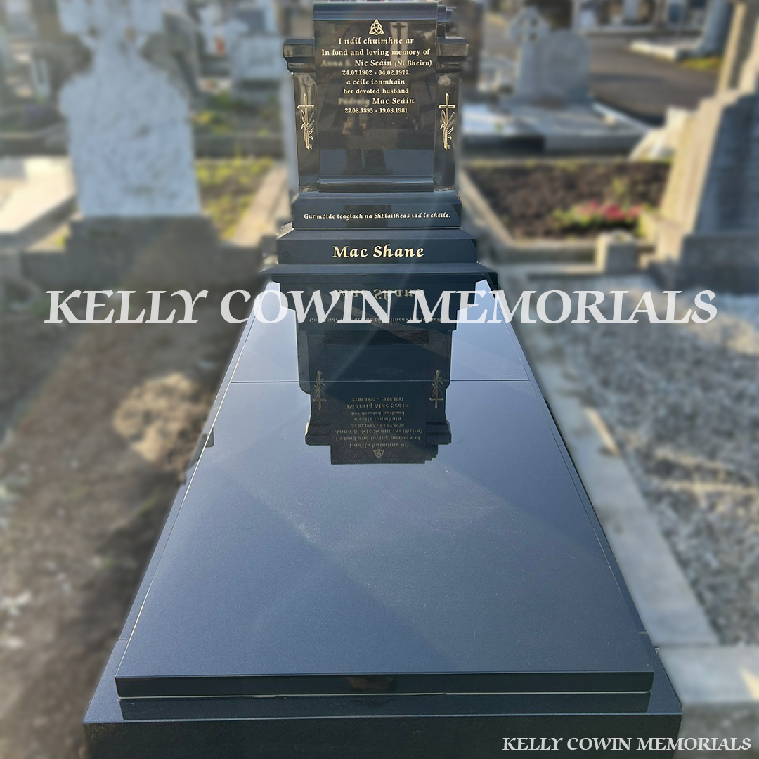 Front view of custom Black Granite scroll-shaped headstone with kerbing and covering slab erected in Deansgrange Cemetery Dublin by Kelly Cowin Memorials