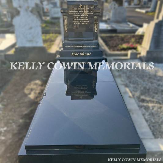 Front view of custom Black Granite scroll-shaped headstone with kerbing and covering slab erected in Deansgrange Cemetery Dublin by Kelly Cowin Memorials