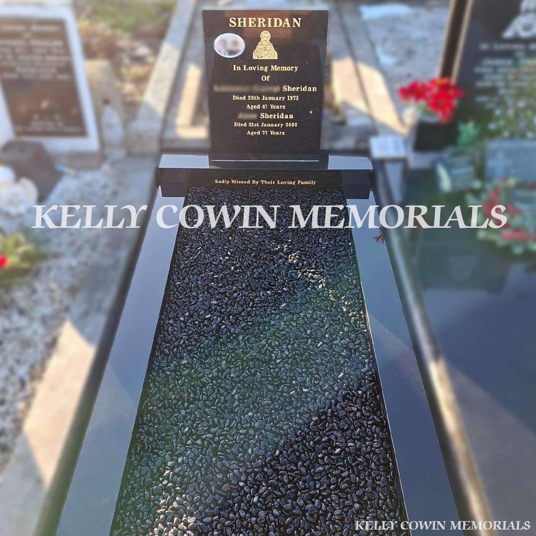 Front view of black granite square headstone with gold leaf inscription in Deansgrange Cemetery
