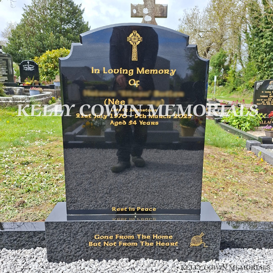Close-up of gold engraved inscription on black granite Top Nine headstone