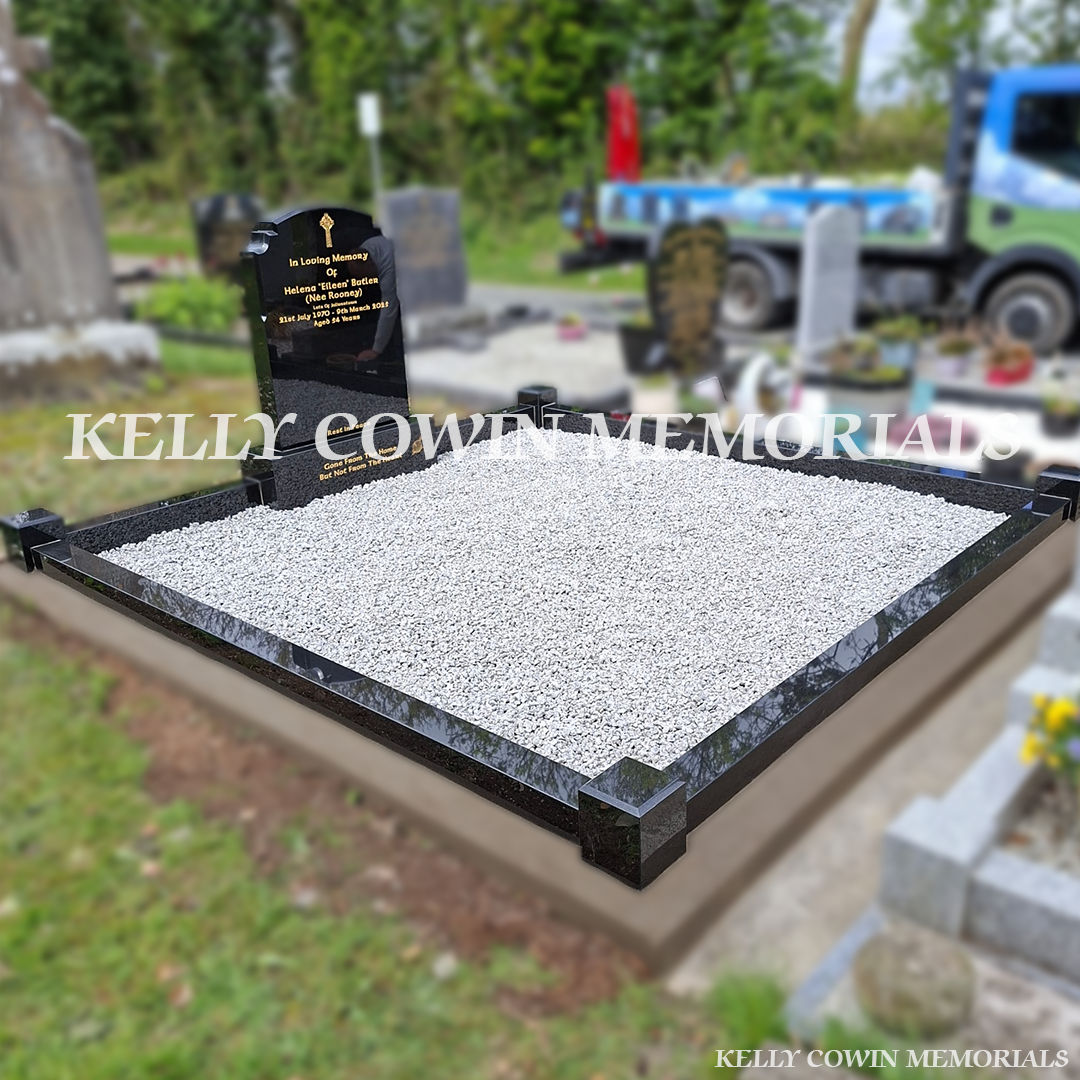 Side view of black granite memorial with kerbing and grey chippings