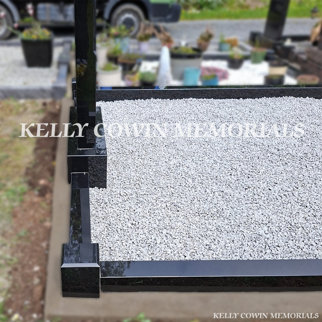 Side view of black granite memorial with kerbing and grey chippings
