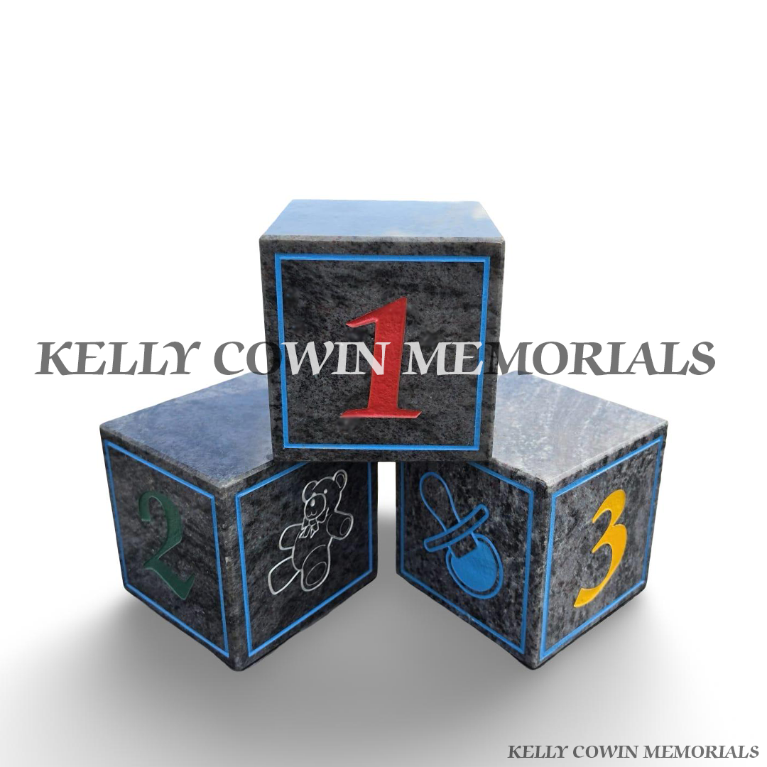 Personalised Blue Lagoon granite baby memorial blocks with coloured engraved wording, numbers, handprints and child-themed memorial images by Kelly Cowin Memorials.