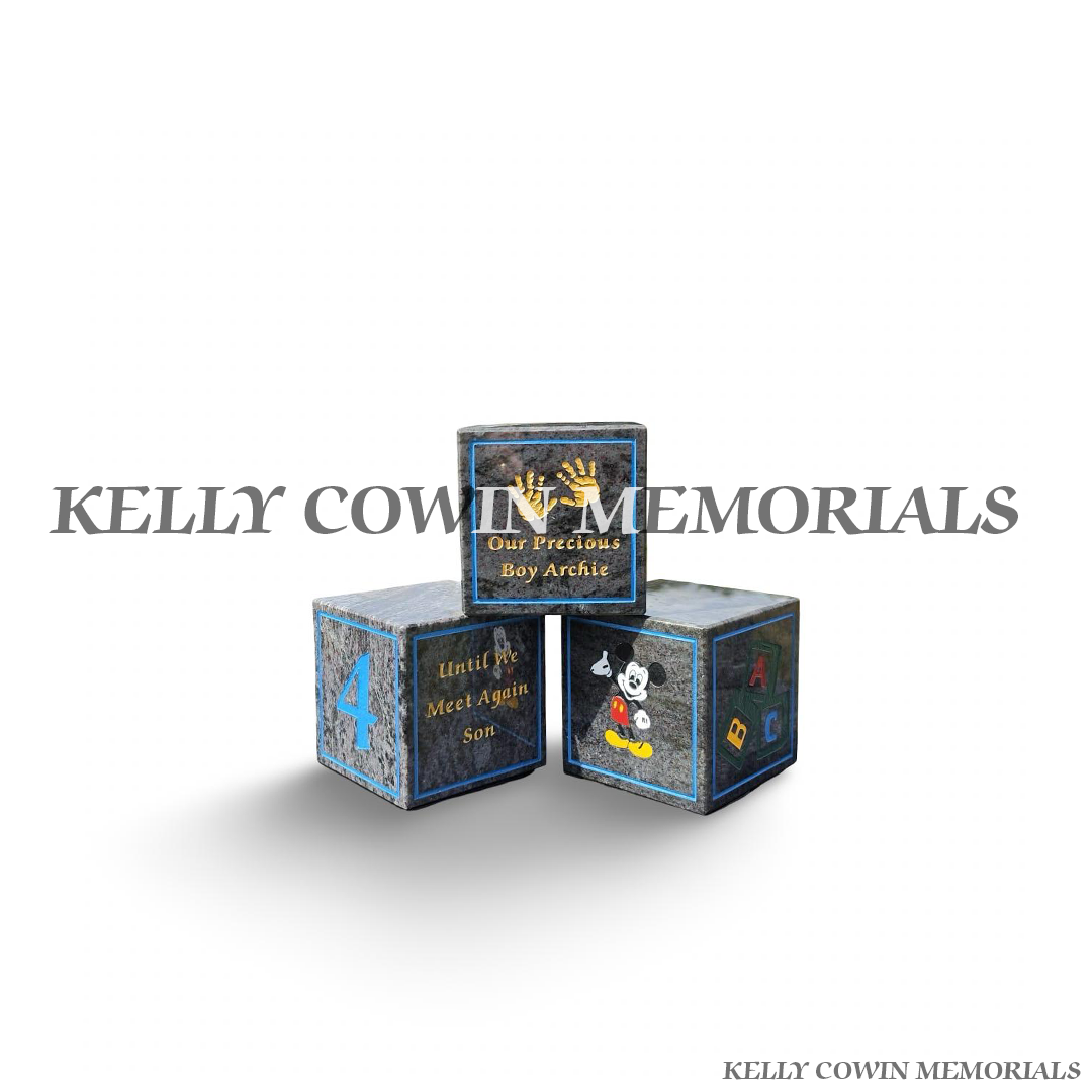 Personalised Blue Lagoon granite baby memorial blocks with coloured engraved wording, numbers, handprints and child-themed memorial images by Kelly Cowin Memorials.